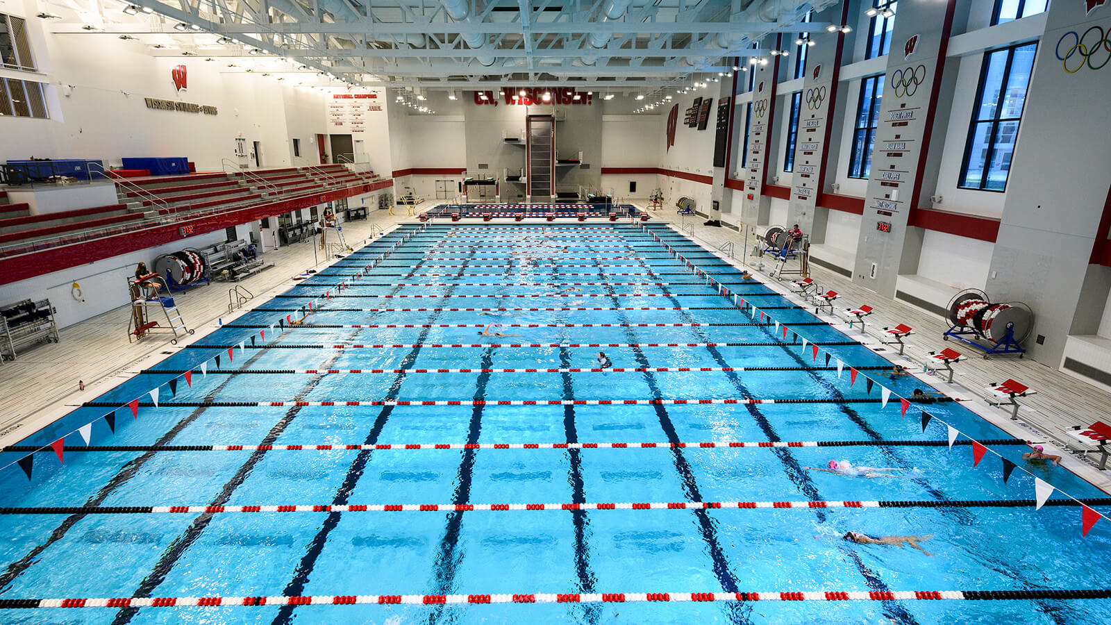 Long view of the new swimming pool showing a diving well and bleacher seating.
